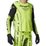 Bright yellow and black Shift motocross outfit on a gray background