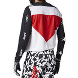 Person wearing a black, white, and red motocross outfit with 'Shift' branding on a gray background