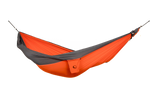 Ticket to the Moon Original Outdoor Hammock set up between trees in a park. Orange Dark Grey