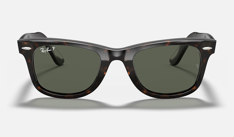 Ray-Ban Wayfarer Classic sunglasses in various colors with polarized and gradient lenses, featuring acetate frames and iconic logo.